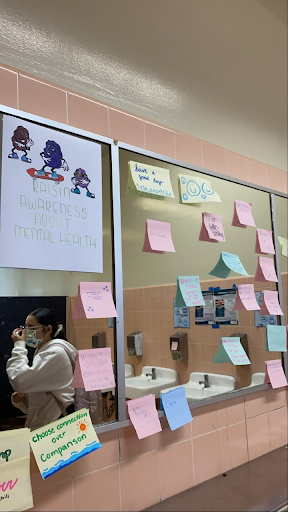 This photo depicts the girls 400 bathroom after students started adding their own post-its to the initial project.
