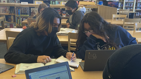 PHOTO COURTESY OF Karly Vincente-Barrios: This photo depicts Zuriel Vaca peer-tutoring Natalia Ruiz in the library.