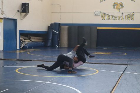 Two of our female Millikan wrestlers practice in the wrestling room. 