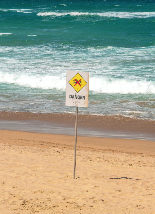 A Danger sign that forbids swimming in the water. Photo from pexels.com.