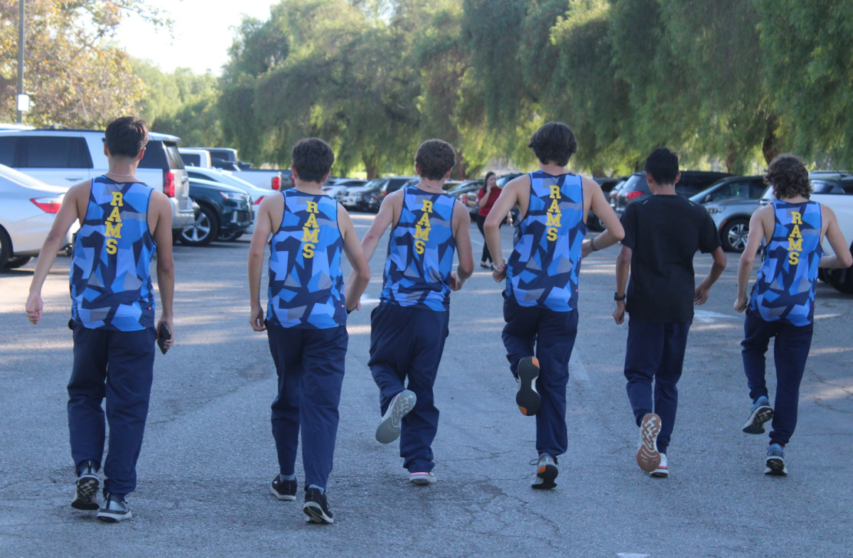 Photo of boys cross country team preparing for one of their final competitions.