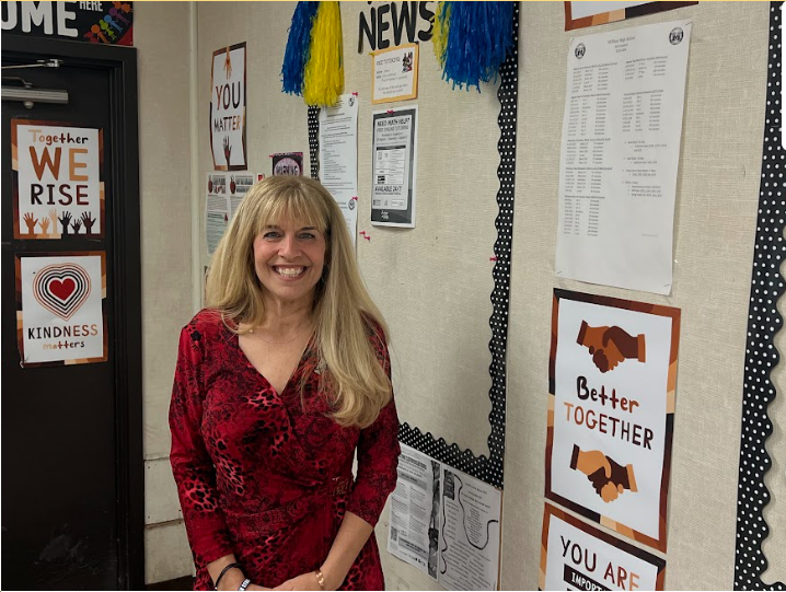 Photo of Ms. SId Shapiro outside of her classroom.