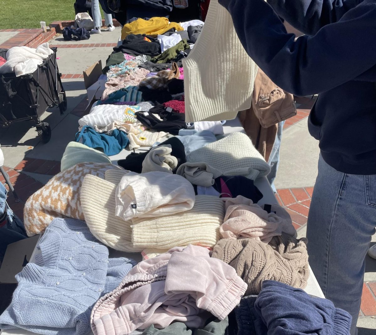 Photo of people digging through the donated clothing. 