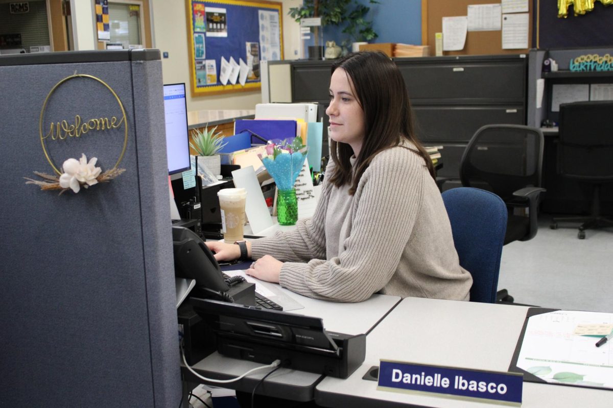 Photo of Mr. Ibasco working at her desk.