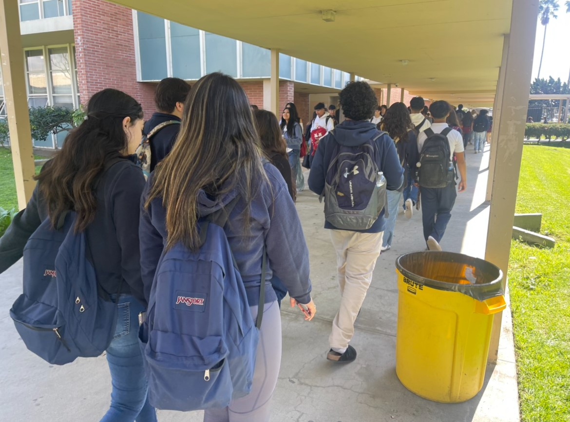 Photo of groups of students walking to class during passing period.