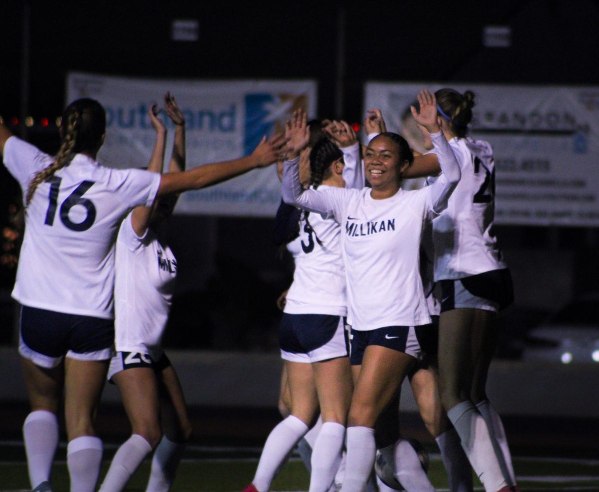 Photo of senior varsity captain Audrey Stewart celebrating a goal. 