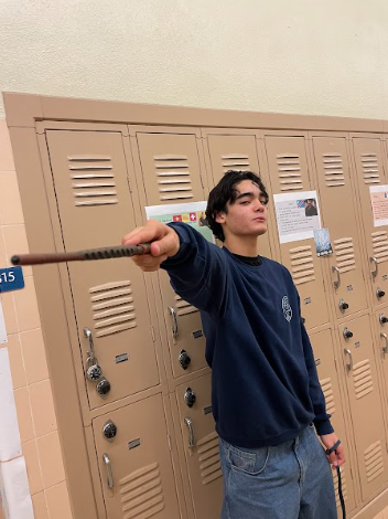 Photo of student pointing a wand.