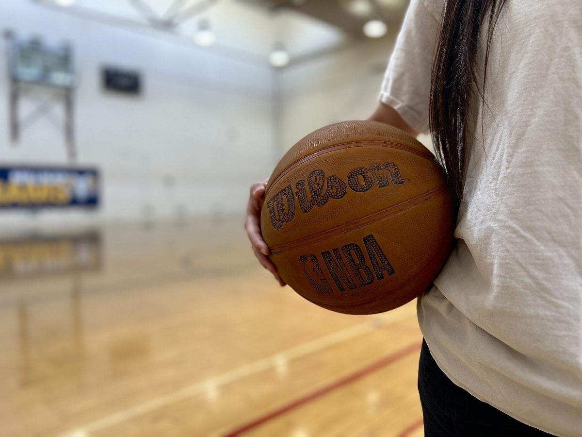 Photo of a girl holding a basketball.