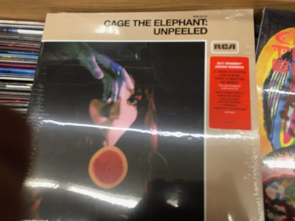 A photo of a Cage the Elephant record in a record shop. 