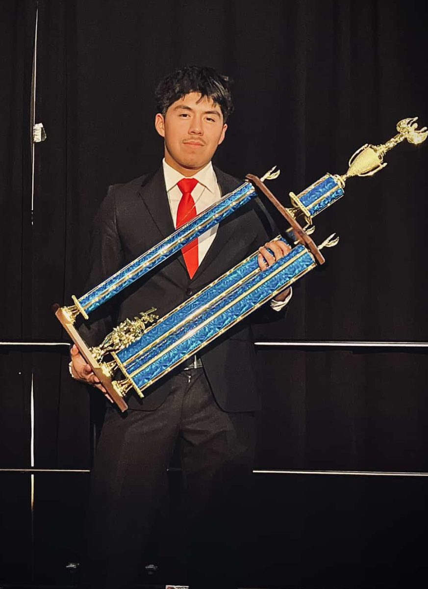 Photo of Perez with the First Place trophy.