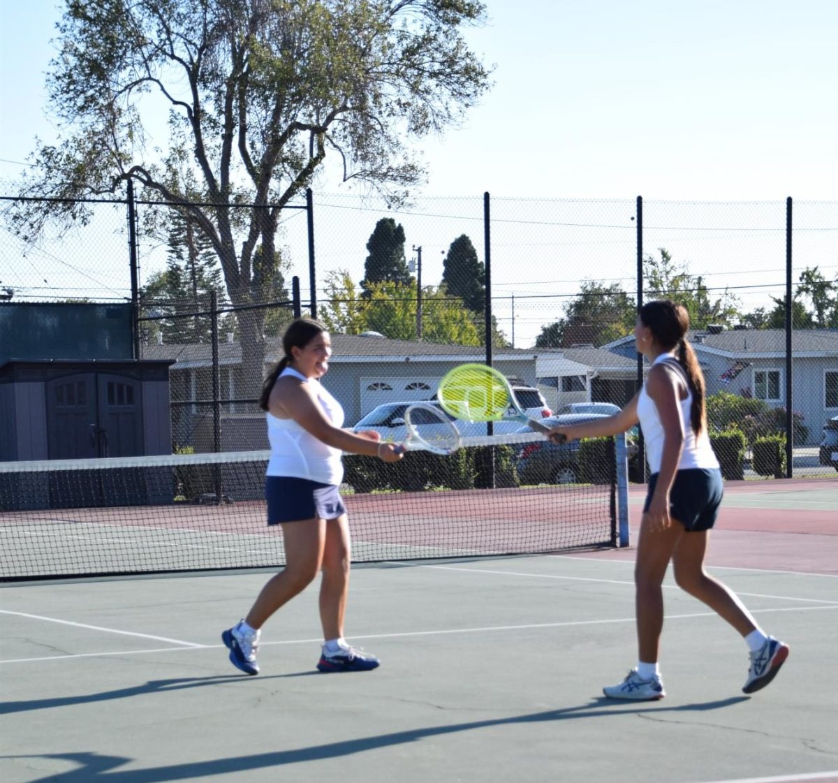 Photo of Varsity tennis players in a match