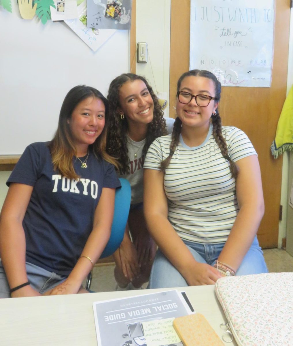 Photo of Rose, Kayla and Brina in the journalism classroom